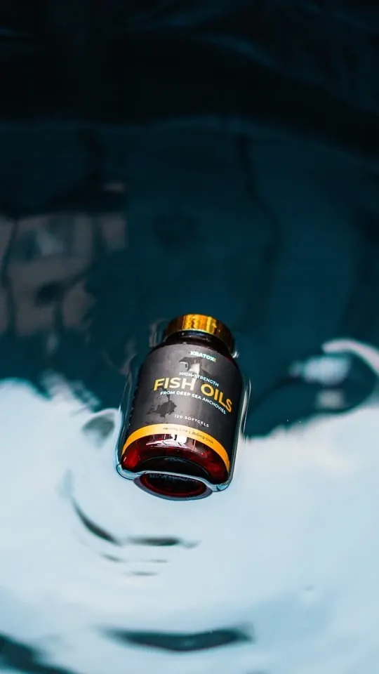AOB fish oils bottle above rippling water