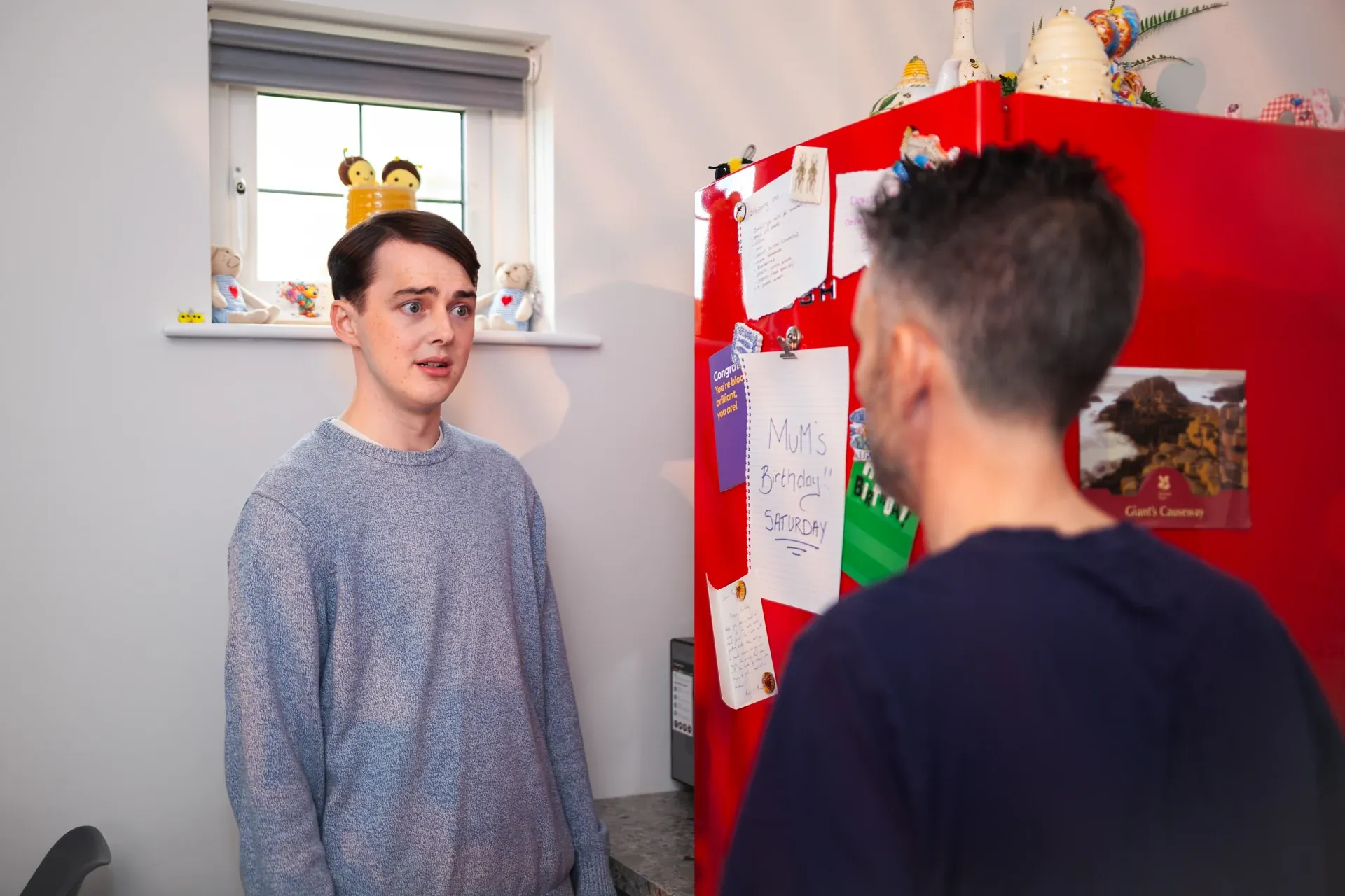 A two-person kitchen scene in progress