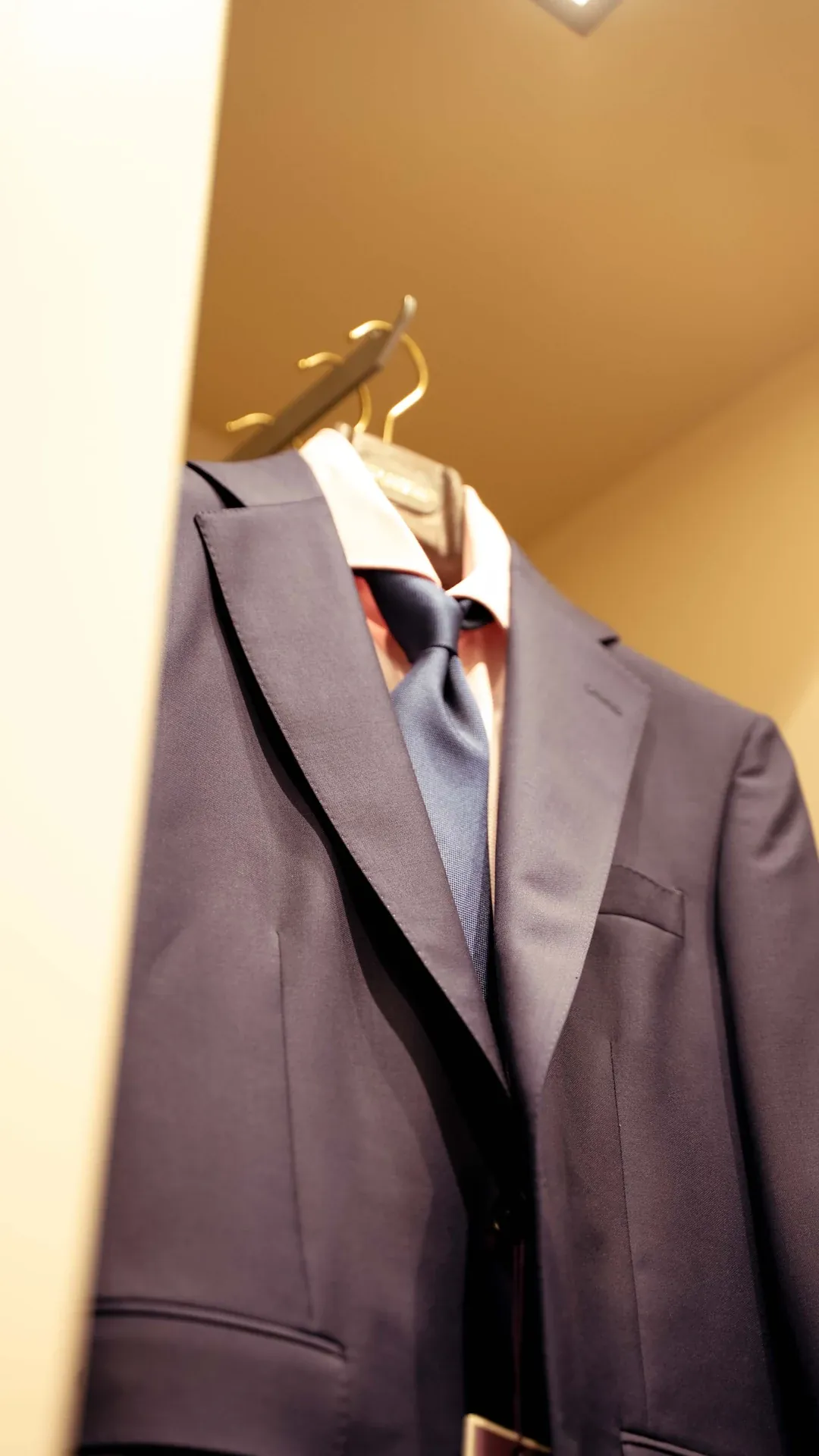 Suit, shirt and tie in a warm-lit display