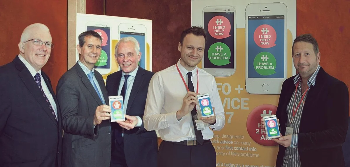 Team and partners presenting a support app at its launch
