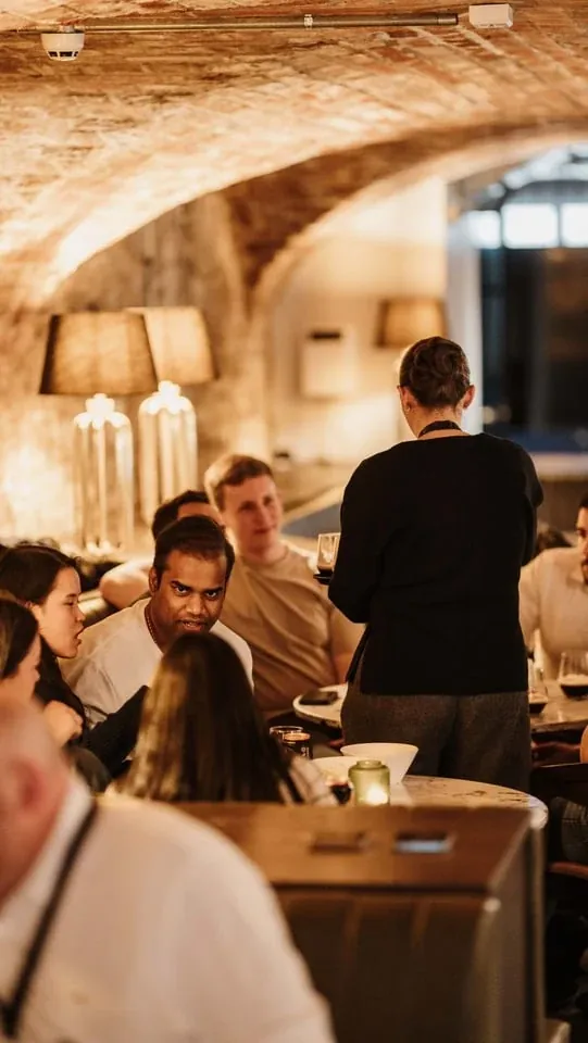 Guests gathered around a table during a Kindred event