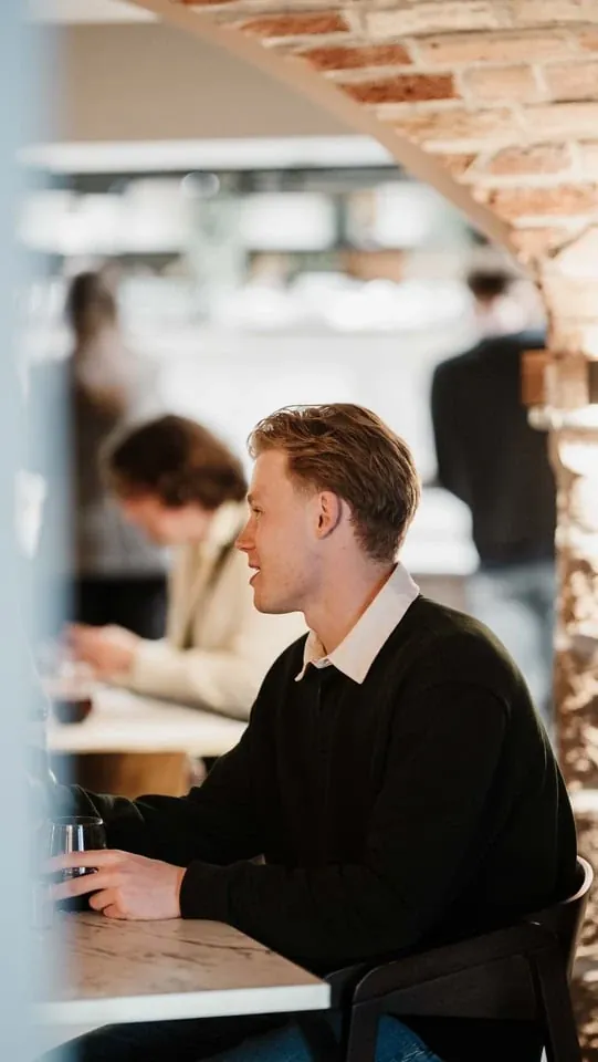 Guest seated at a table during a Kindred event