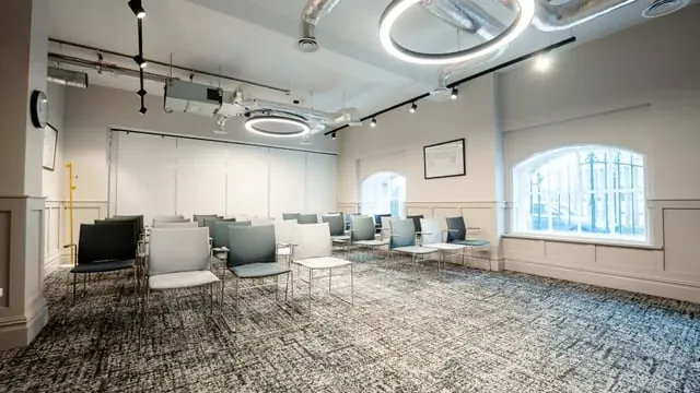 Seating and circular ceiling lights in a Kindred meeting space