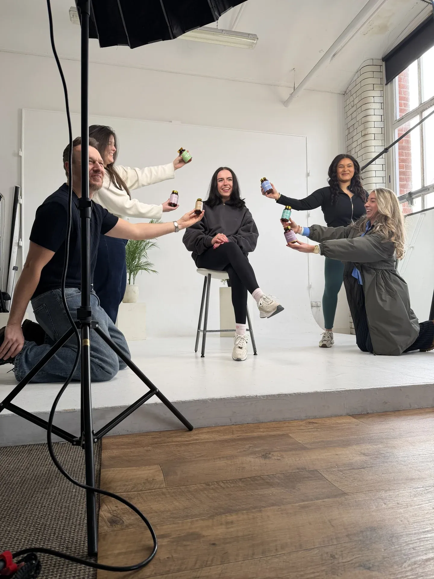 The team directing a portrait session in a photography studio
