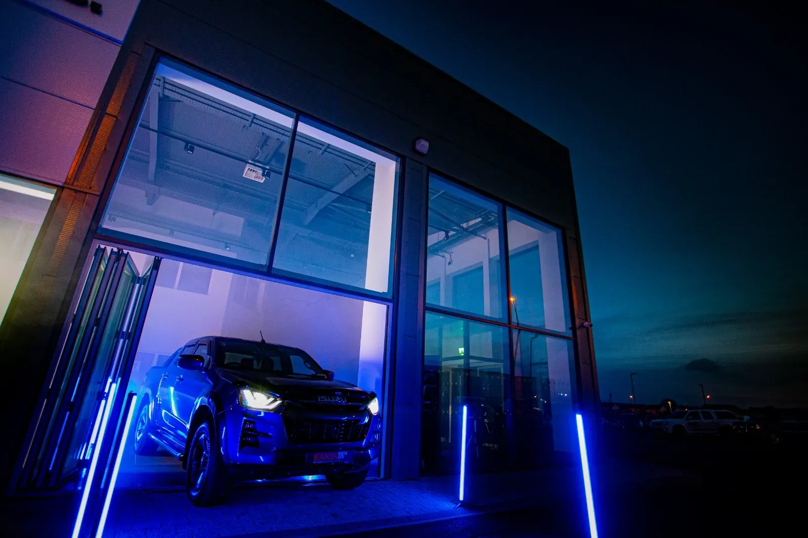 Car framed inside a blue-lit architectural set