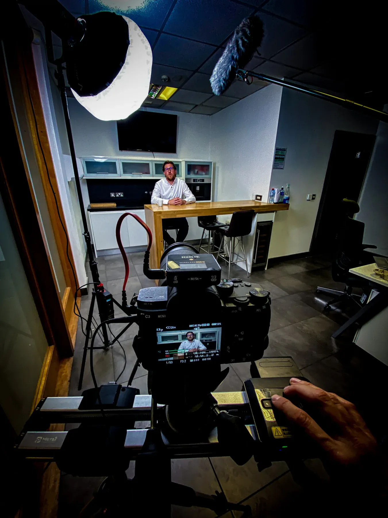 Interview framed through a production camera and softbox