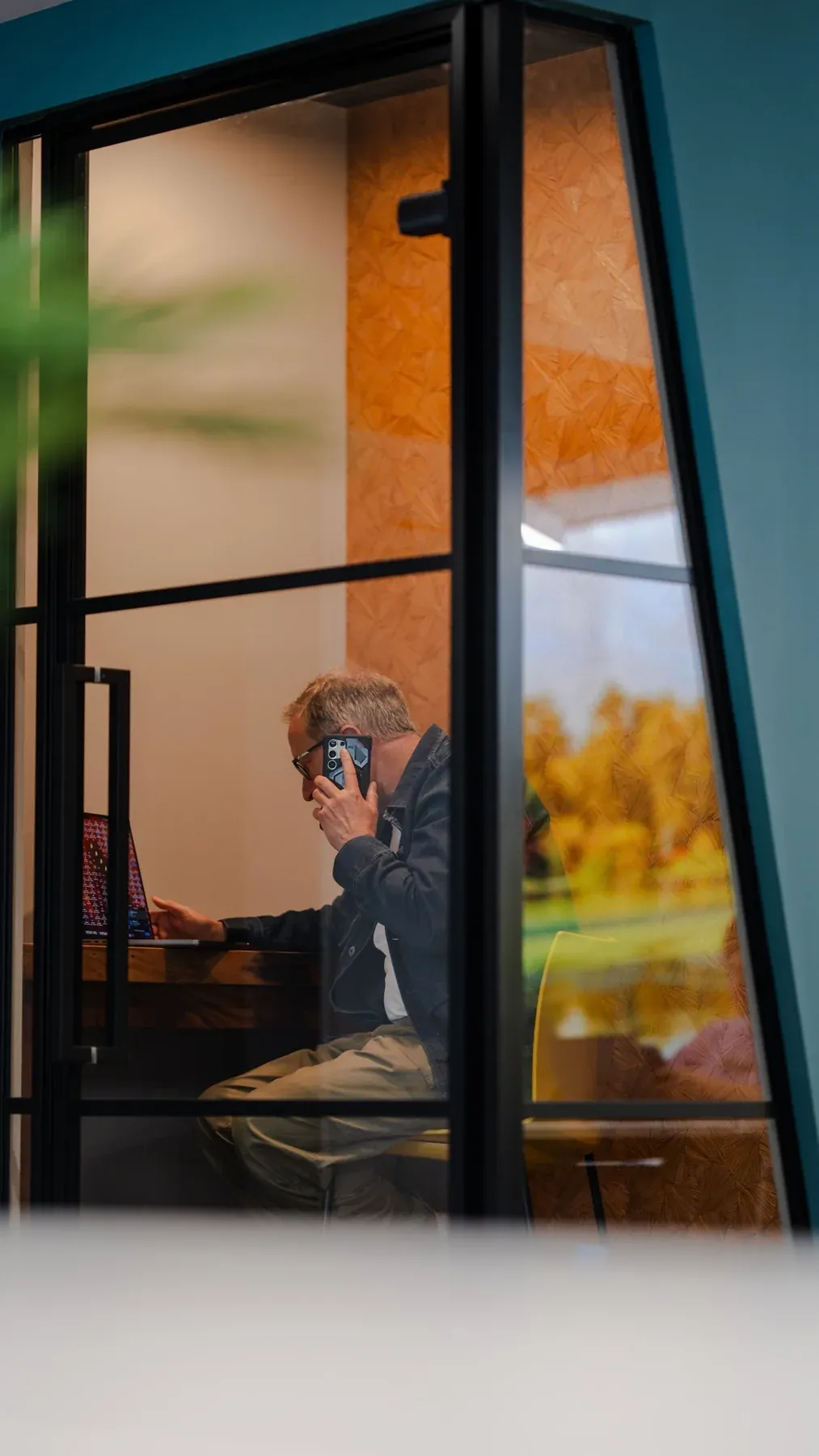 Warm office interior seen through a glass door