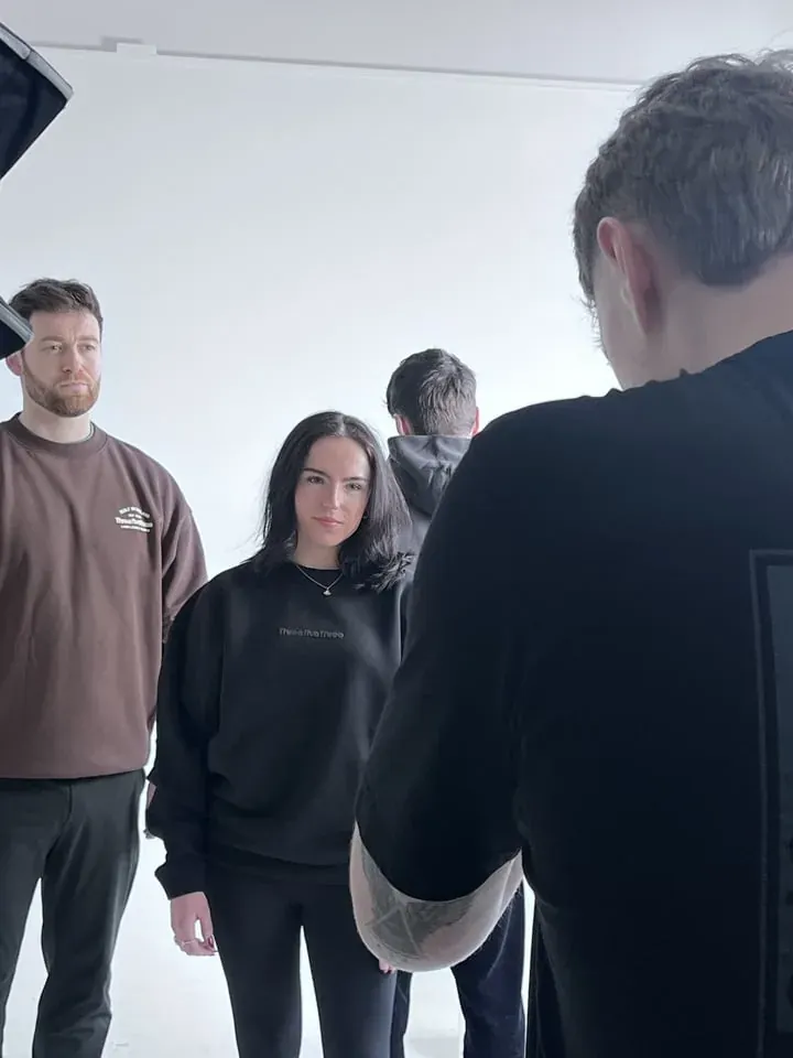 Photographer directing a group in the studio